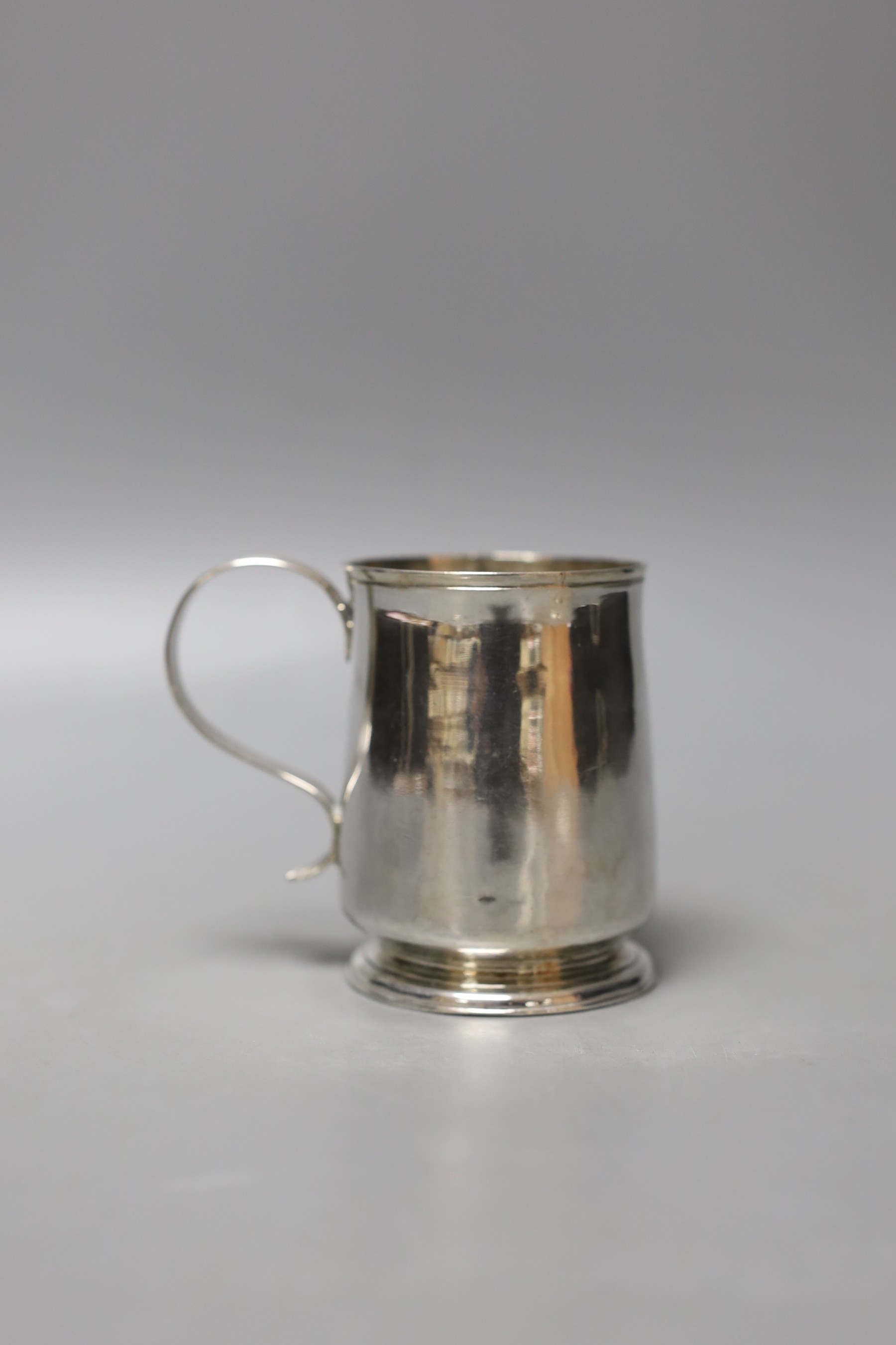 A small late George I silver mug, with reeded handle, by George Greenhill Jones, London, 1725, 77mm, 112 grams, (a.f.).